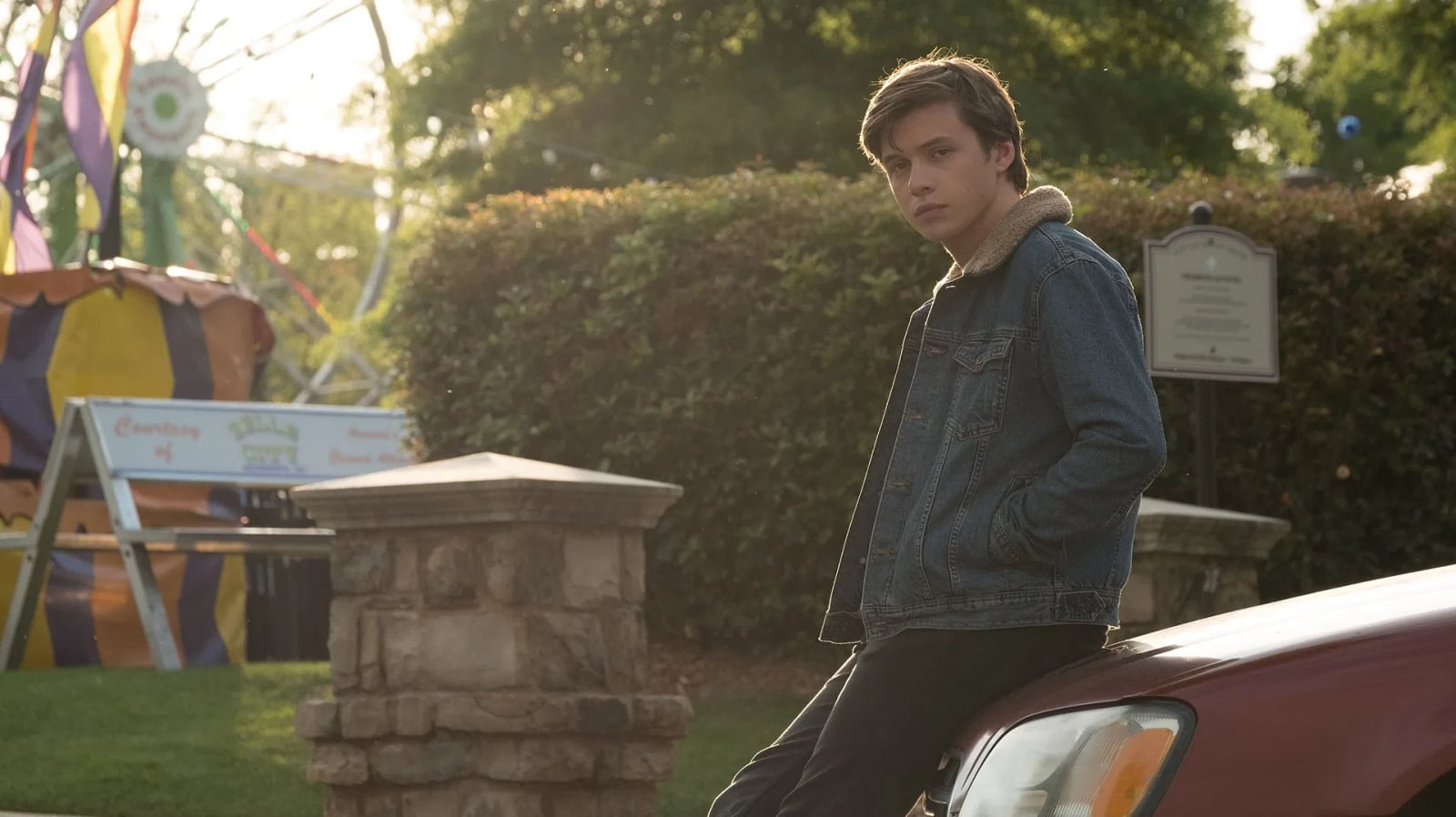 Simon Spier steht im Schulflur, umgeben von Schülern, nachdenklicher Blick – Szene aus Love, Simon